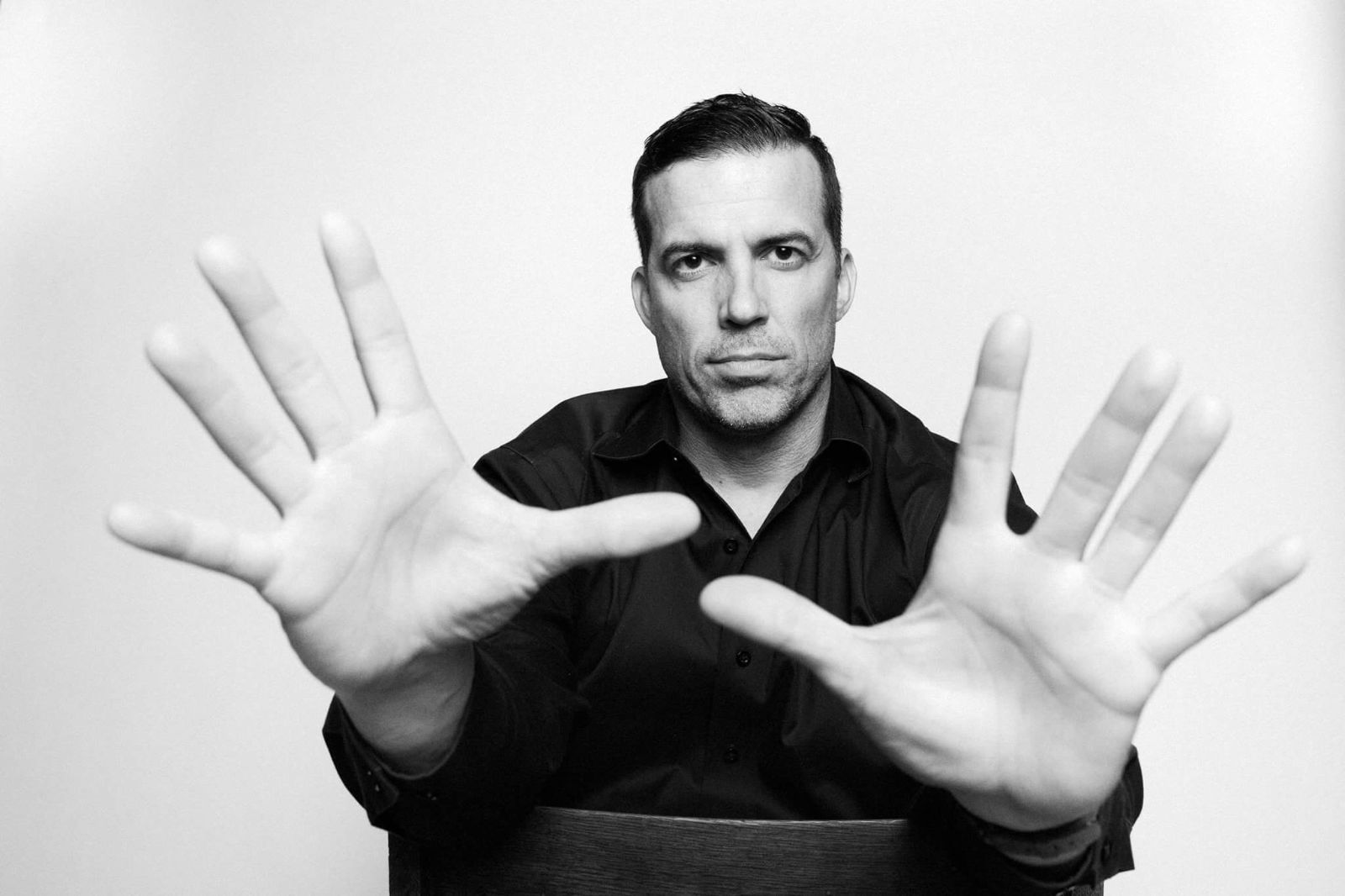 Laurent Lebihan holding both hands up toward the camera